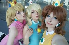 three women dressed up as princesses posing for the camera with their arms around each other