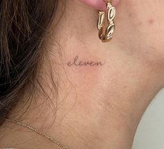 a woman's neck with the word ellen tattooed on her left side behind her ear