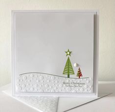 a white card with a christmas tree on it