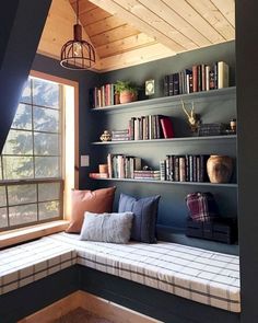 a window seat with bookshelves in the corner