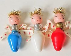 three small christmas lights are sitting next to each other on a white surface with red, white and blue decorations