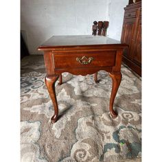 an antique wooden table with marble top