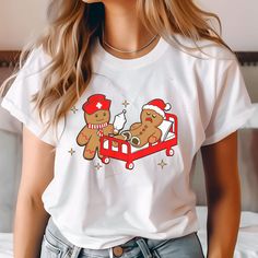 Here's a short, captivating product description for the "Did you try Icing it Nurse" shirt: 🍪❄️ Spread holiday cheer and medical humor with our "Did you try Icing it Nurse" t-shirt! This adorable design features gingerbread nurses in action, bringing a whimsical twist to healthcare. The comfy white tee showcases a witty scene of one gingerbread nurse tending to another with an IV bag - perfect for nurses with a sweet sense of humor. Ideal for wearing during holiday shifts or as a fun off-duty s Gingerbread Shirt, Iv Bag, Funny Nurse Shirts, Funny Nurse, Medical Humor, Christmas Funny, Nurse Shirt, Nursing Tshirts, Nurse Humor