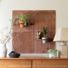 some plants are sitting on top of a wooden shelf