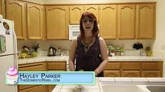 a woman standing in a kitchen next to a white refrigerator freezer with the words hayley parker on it