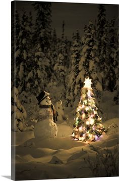 a snowman next to a christmas tree in the snow with lights all around it