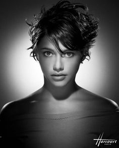 a black and white photo of a woman with wavy hair