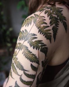 a woman with green leaves on her arm