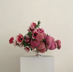 a vase filled with pink and white flowers