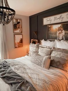 a bedroom with a chandelier and pictures on the wall