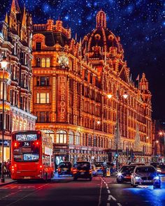 a city street filled with lots of traffic under a sky full of stars and lights