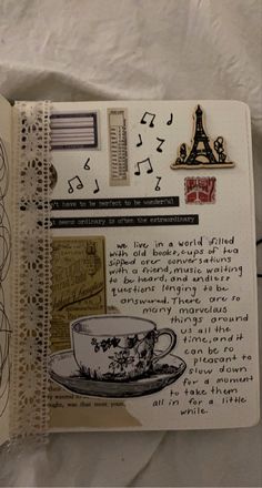 an open notebook with various stickers and writing on it, including a coffee cup