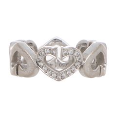 A stylish vintage Cartier 'C de Cartier' diamond heart ring set in 18k White Gold. The ring is composed of six signature Cartier double C's; joined together to form heart motifs. Set to the centre of the ring is a single pavé set diamond heart motif that adds the perfect amount of additional sparkle to the piece! Due to the design and size of the piece, this ring could be worn for a variety of occasions. The subtlety of the diamonds allows the piece to be worn for everyday and then accessorised Cartier Diamond, Vintage Cocktail Ring, Diamond Heart Ring, Heart Motif, Diamond Cocktail Rings, Eternity Ring Diamond, Diamond Heart, Vintage Cartier, Eternity Ring