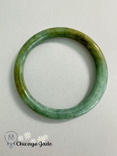 This beautiful jade bracelet from Myanmar makes a lovely gift. Crafted from natural yellow-green round jadeite gems, it exudes elegance in its understated and authentic design. As jade is a symbol of strength, wisdom and good fortune in many Asian cultures, this bracelet carries meaningful symbolism. Each gemstone has been carefully selected for its vibrant color and lustrous shine. Strung on gold-plated wire, it has a simple yet refined look that can be dressed up or down. Its untreated natural state preserves the integrity of centuries-old geological formation process. A timeless piece, it will be treasured for years to come. Classic Green Round Bangle, Holistic Hand-strung Jade Jewelry, Yellow Round Jade Jewelry, Hand-strung Gold Jade Bracelets, Hand-strung Round Jade Bracelets, Jade Bracelet Bangles Chinese, Symbols Of Strength, Jade Bangle, Jade Bracelet