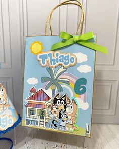 there is a paper bag with the word thiago on it next to a party hat