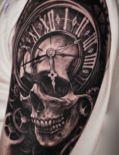 a man with a clock and skull tattoo on his arm