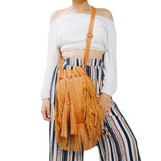 The perfect bohemian bag doesn't exi... Does exist! Check out this amazing Boho Tribe Fringe Crossbody Bag! Literally the whimsical fringe bag every bohemian soul dreams of – I mean, look at the craftsmanship of this fringe stunner! An amazing jewel of artisan creation that will turn all your Boho sisters's heads, this unique fringe crossbody bag offers a truly distinctive ethnic-inspired design, featuring stunning braided details and long leather fringes. A gorgeous combination of Vintage Triba Bohemian Fall Bags With Tassels, Bohemian Shoulder Bag With Tassels For Fall, Bohemian Shoulder Bag For Fall, Bohemian Bucket Bag With Braided Handles, Bohemian Bucket Bag With Braided Handles For Everyday, Bohemian Beach Crossbody Satchel, Bohemian Bags With Adjustable Strap For Fall, Bohemian Hobo Satchel Bag For Summer, Bohemian Shoulder Bag With Adjustable Strap For Fall