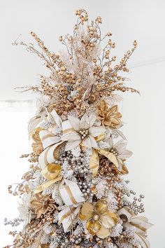 a decorated christmas tree with gold and silver decorations