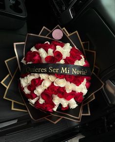 a bouquet of red, white and blue flowers in the center of a car