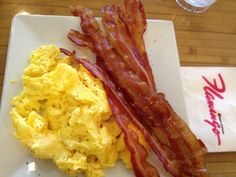 bacon and scrambled eggs on a white plate