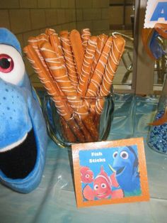 an assortment of snacks are displayed on a table in front of a cookie monster mask