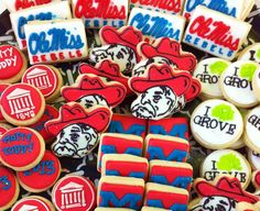 many decorated cookies are displayed on a table