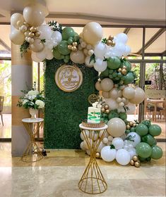 balloons and greenery decorate the entrance to an event