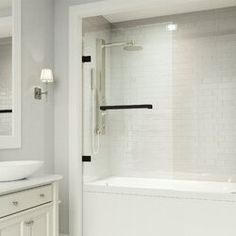 a white bathroom with two sinks and a bathtub