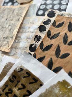 several pieces of paper with black and white designs on them