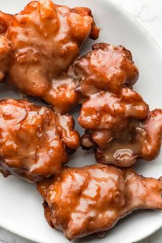 chicken wings covered in caramel sauce on a white plate