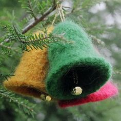 three felt bells hanging from a tree branch