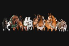 five horses are standing in a row with wreaths on their heads