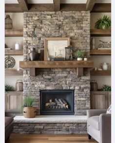 a living room with a stone fireplace and shelves on either side of the fire place