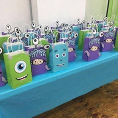 there are many small bags on the table with monsters painted on them and one has eyes