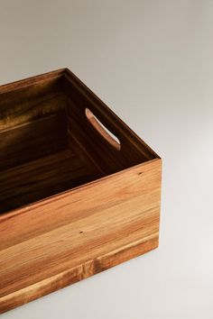 an empty wooden box on a white surface