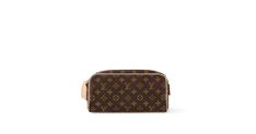 Discover Louis Vuitton Dopp Kit Toilet Pouch: An indispensable travel companion, this signature Dopp kit is crafted from classic Monogram canvas, trimmed with natural cowhide. The spacious interior holds grooming needs securely, with a zipped pocket for smaller items. The wide leather handle ensures a comfortable carry; it also serves to hang the bag from a bathroom hook. Luxury Rectangular Cosmetic Bag For On-the-go, Brown Leather Handle Travel Pouch, Rectangular Travel Pouch With Leather Handles, Rectangular Monogram Canvas Bag With Luggage Sleeve, Luxury Leather Cosmetic Bag With Zipper Closure, Luxury Leather Travel Cosmetic Bag, Classic Monogram Canvas Pouch For Everyday Use, Luxury Travel Cosmetic Bag With Zipper, Luxury Leather Cosmetic Bag For Travel