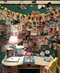 a desk with many pictures on it and a lamp in front of the desk top