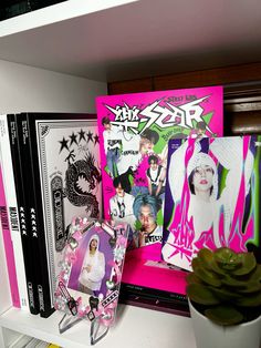 the shelf is covered with various items and magazines, including posters, cds, and books