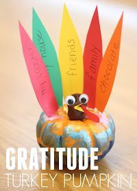 a paper turkey sitting on top of a wooden table next to a sign that says, grateful turkey pumpkin