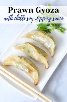 some food is sitting on a plate with chopsticks next to it and the words prawn gyoza with chilli soy dipping sauce