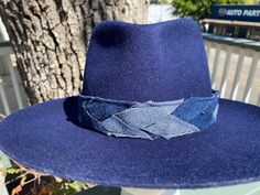 Designer choice!! Take a look at this fun denim blue adjustable hatband with different colors of denim that really make this hatband pop on any style/color of hat. The band is 22.5" x 1.25" and has adjustable navy-blue suede ties in the back so it can fit hats from 22.5-34". The band is secured by two gold tie clamps in the back to give it a nice, finished look. The hat band has been sewn together and treated with fray protector to help keep this hatband looking good for years to come. To comple Casual Adjustable Felt Hat For Country Events, Blue Short Brim Felt Hat For Fall, Adjustable Navy Wide Brim Hat, Blue Fedora With Short Brim For Fall, Blue Wide Brim Adjustable Fedora, Blue Flat Brim Fedora For Fall, Navy Flat Brim Hat, Blue Short Brim Fedora For Fall, Casual Blue Fedora For Fall