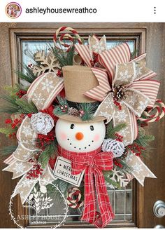 a christmas wreath with a snowman and candy canes on the front door handle