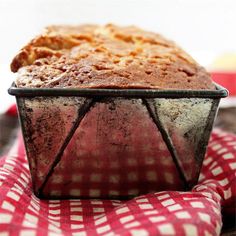 a loaf of bread sitting on top of a red and white checkered cloth