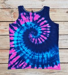 a blue and pink tie - dyed tank top on a wooden background