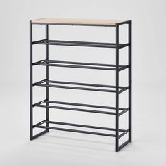 the shelf is black and has three shelves on each side, one with a wooden top