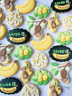 decorated cookies with monkeys, bananas and other words on them that say three is bananas