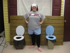 a woman standing in front of three toilets