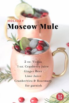 two moscow mules with cranberries and rosemary for garnish