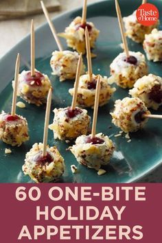 some appetizers are sitting on a plate with toothpicks in them and the words go one - bite holiday appetizers