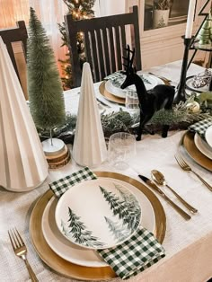 a table set for christmas with plates and napkins